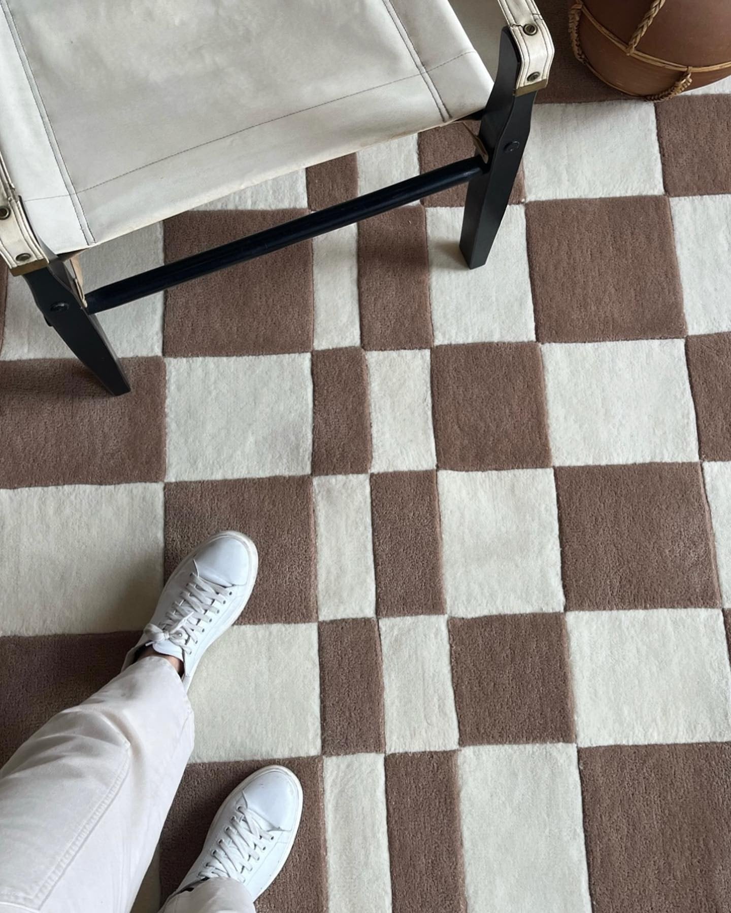 Close detail of the taupe-and-ivory checkerboard rug