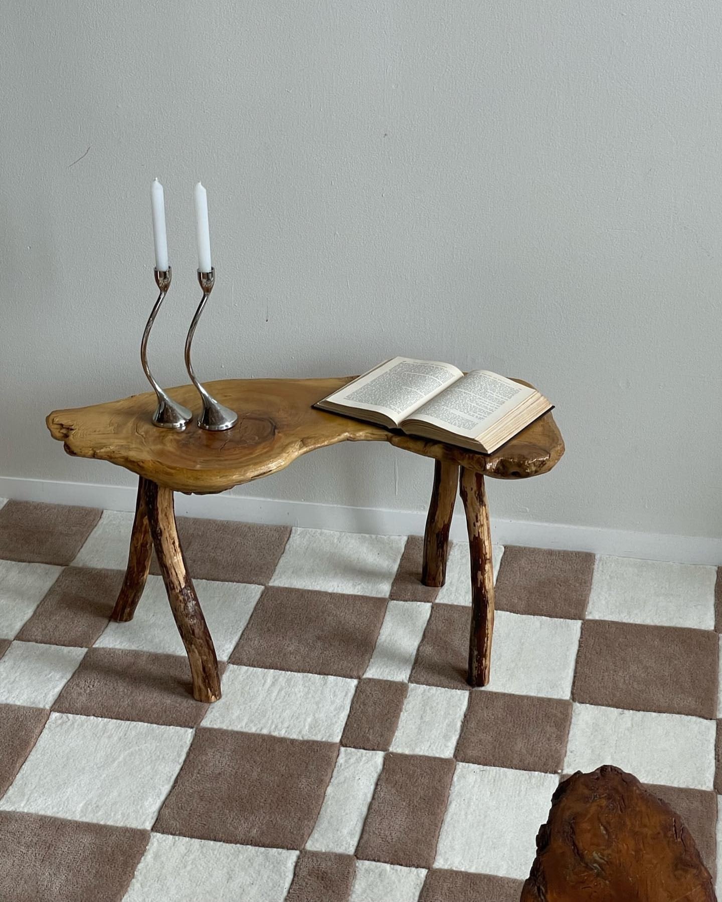 Taupe-and-ivory checkerboard rug in a completed private interior