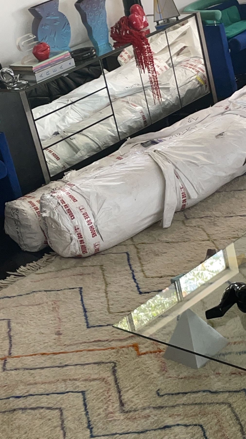 A protected custom rug roll after arrival in an interior