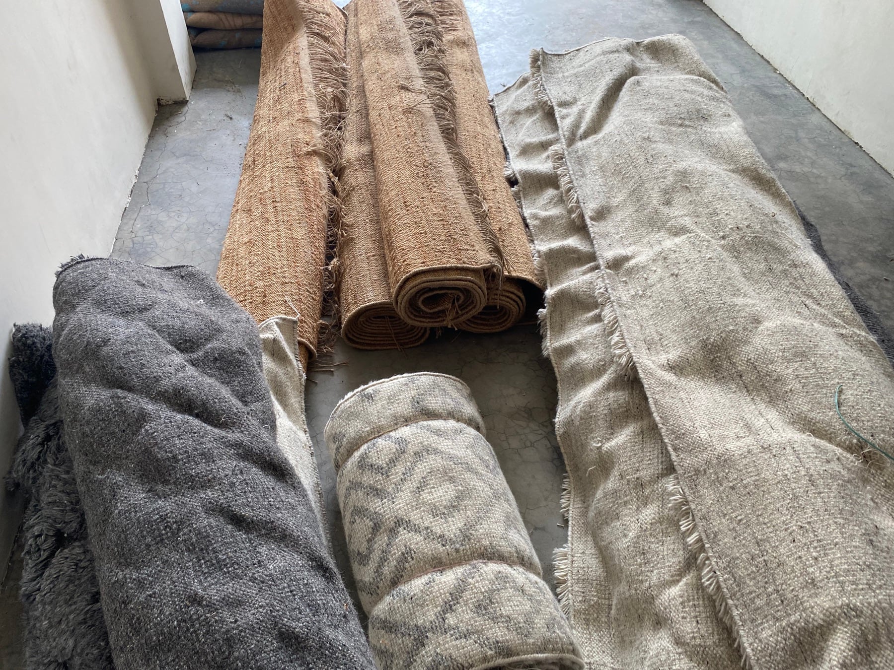 Finished rugs rolled after workshop inspection